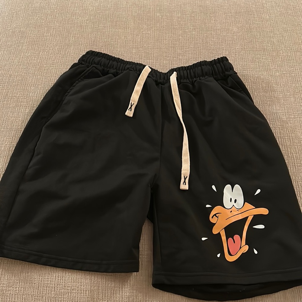 Men’s size Small black with a goofy cartoon duck logo